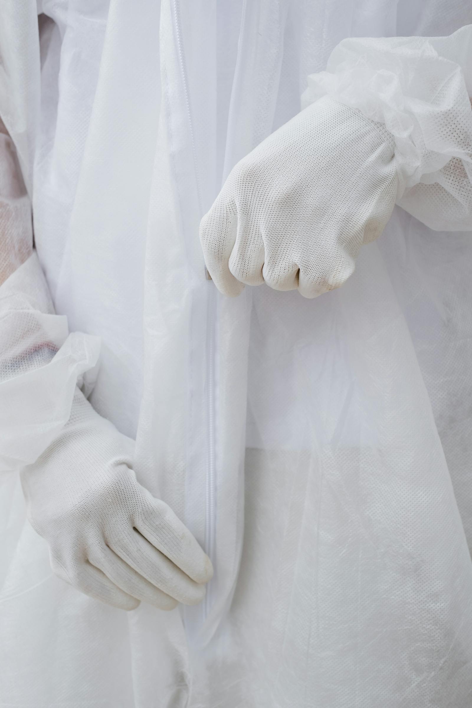 Protective-suit cleanup team reviewing a private property cleanup plan