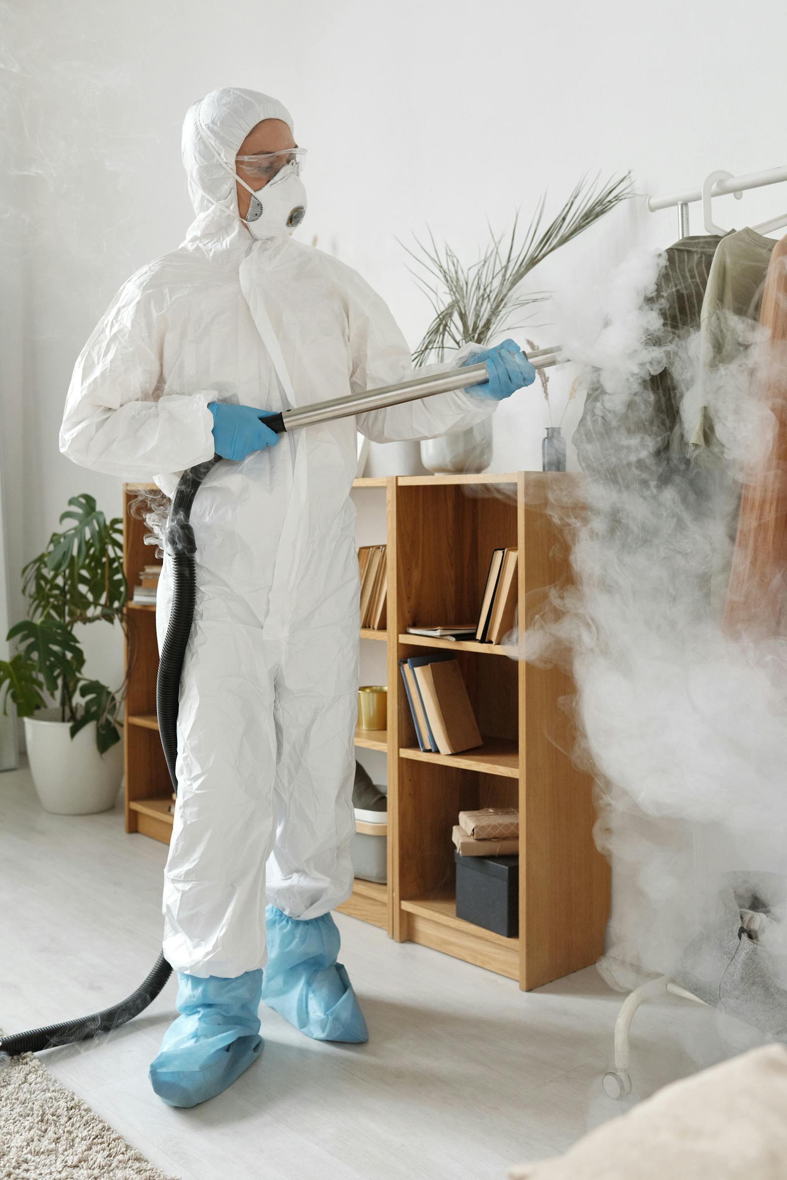 Protective-suit technician performing detailed surface decontamination